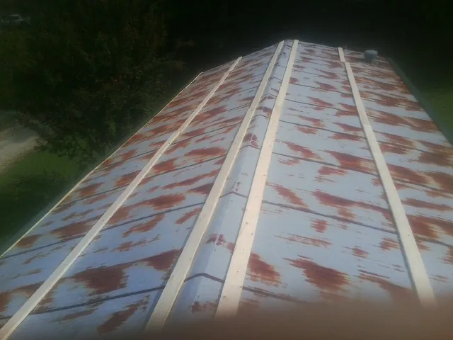 Rusted metal roof panels with new wood purlins before replacement — Storm Damage Roof Repair in Rices Landing by Roofing Brothers